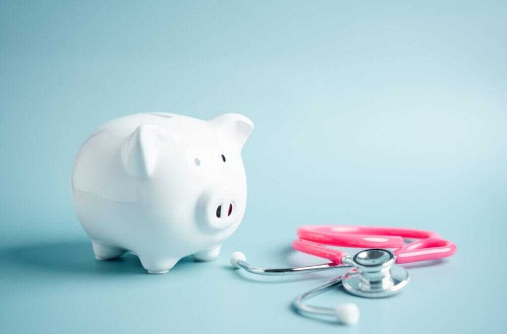 Piggy bank with stethoscope. money health check concept. Open Enrollment Tips and Health care financial checkup and saving for medical insurance cost planning in the future.
