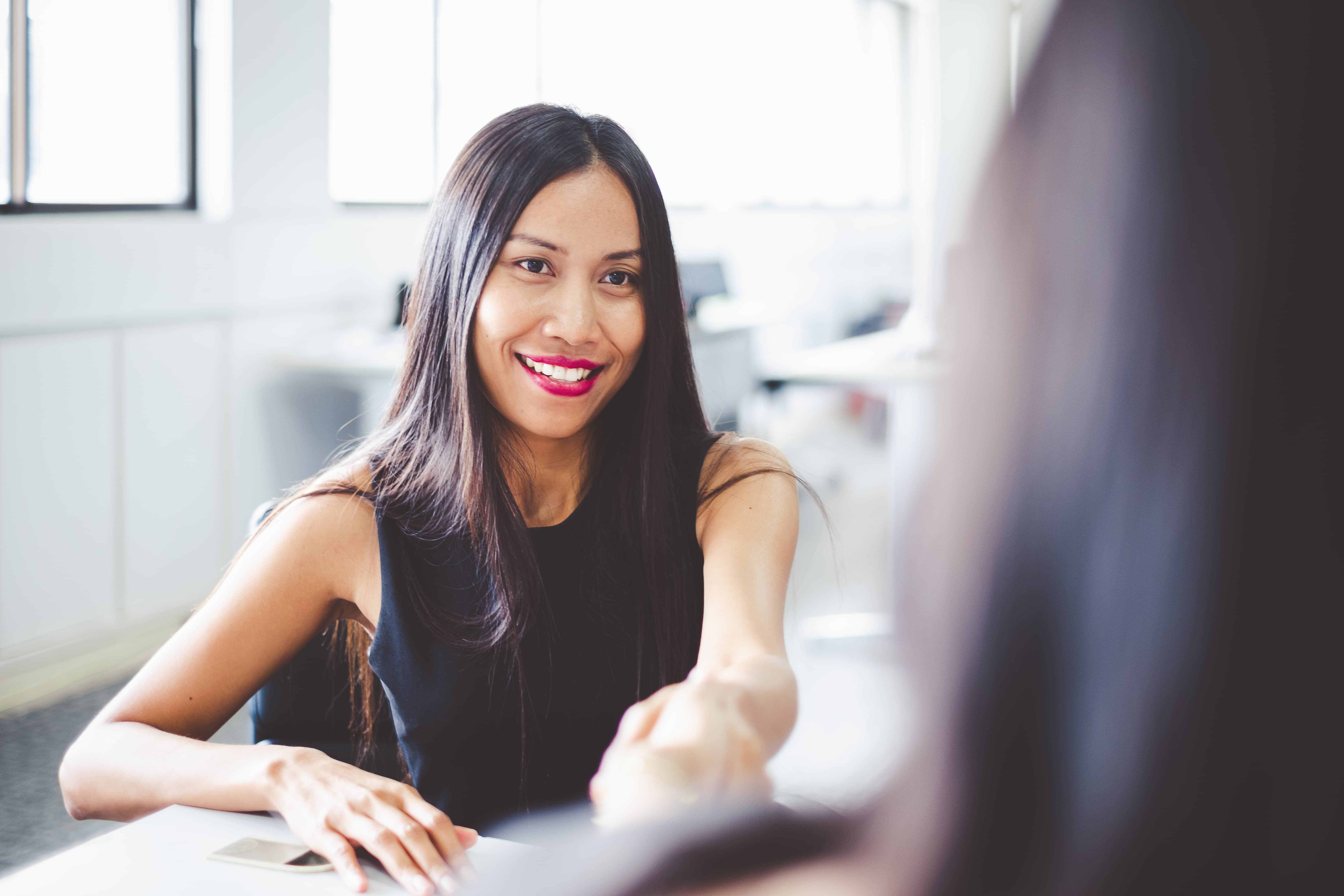 Office manager handshaking employee_210308166-min